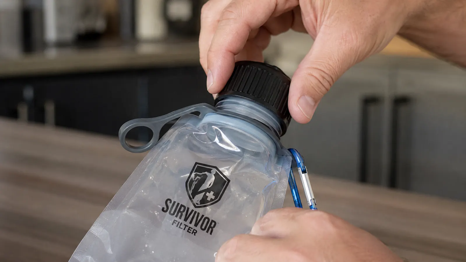 Close-up of a collapsible bottle cap being twisted tight by hand to show the shallow thread design